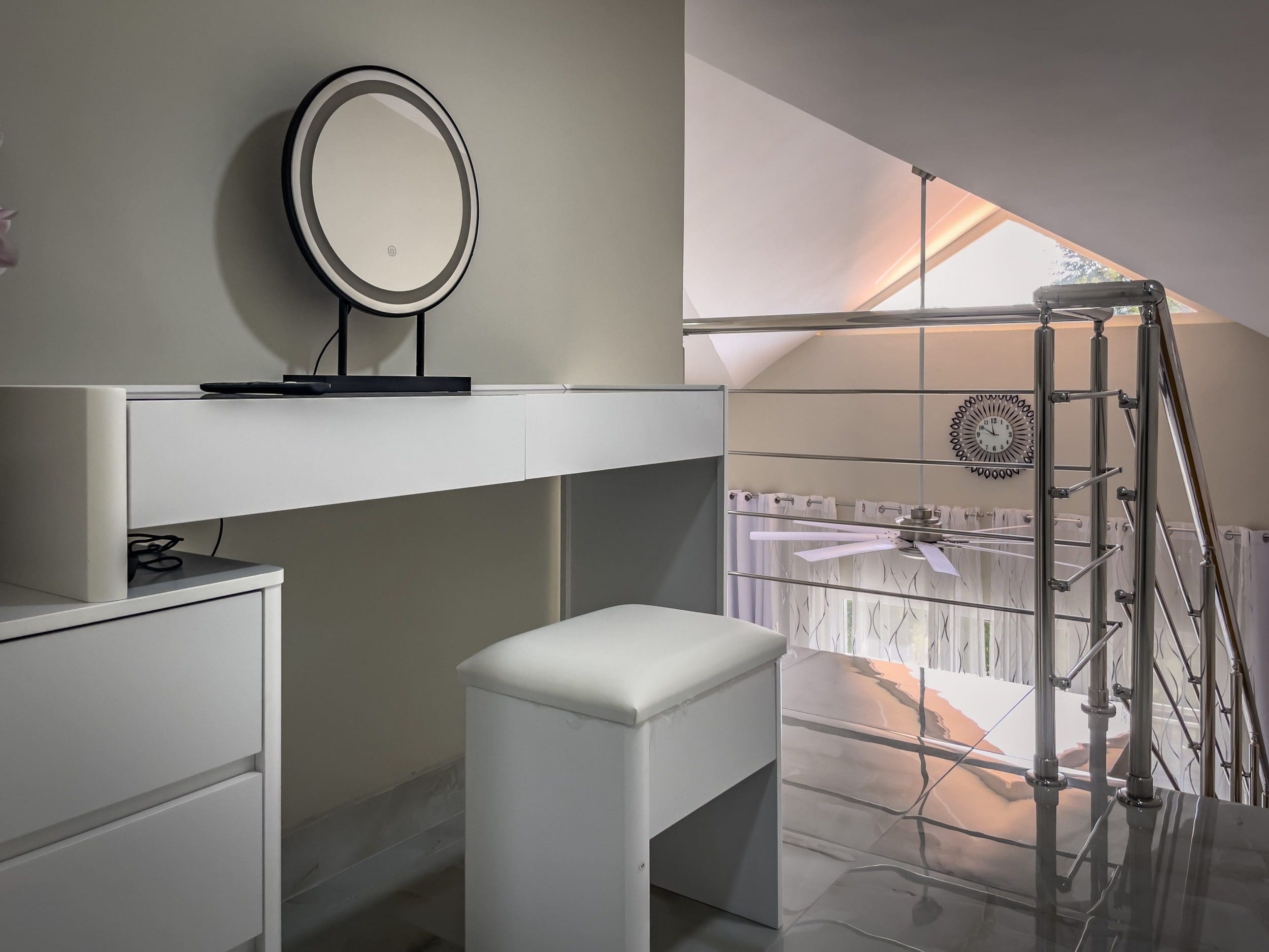 buyDRproperty Modern 1-Bedroom Condo: White vanity with lighted mirror and loft staircase. Sosua Real Estate