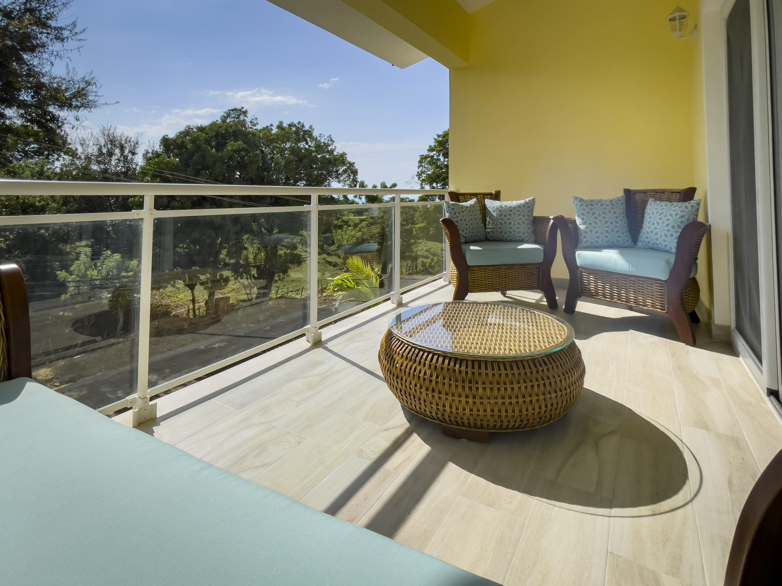 buyDRproperty Modern balcony with wicker furniture in a 1-bedroom condo. Sosua Real Estate