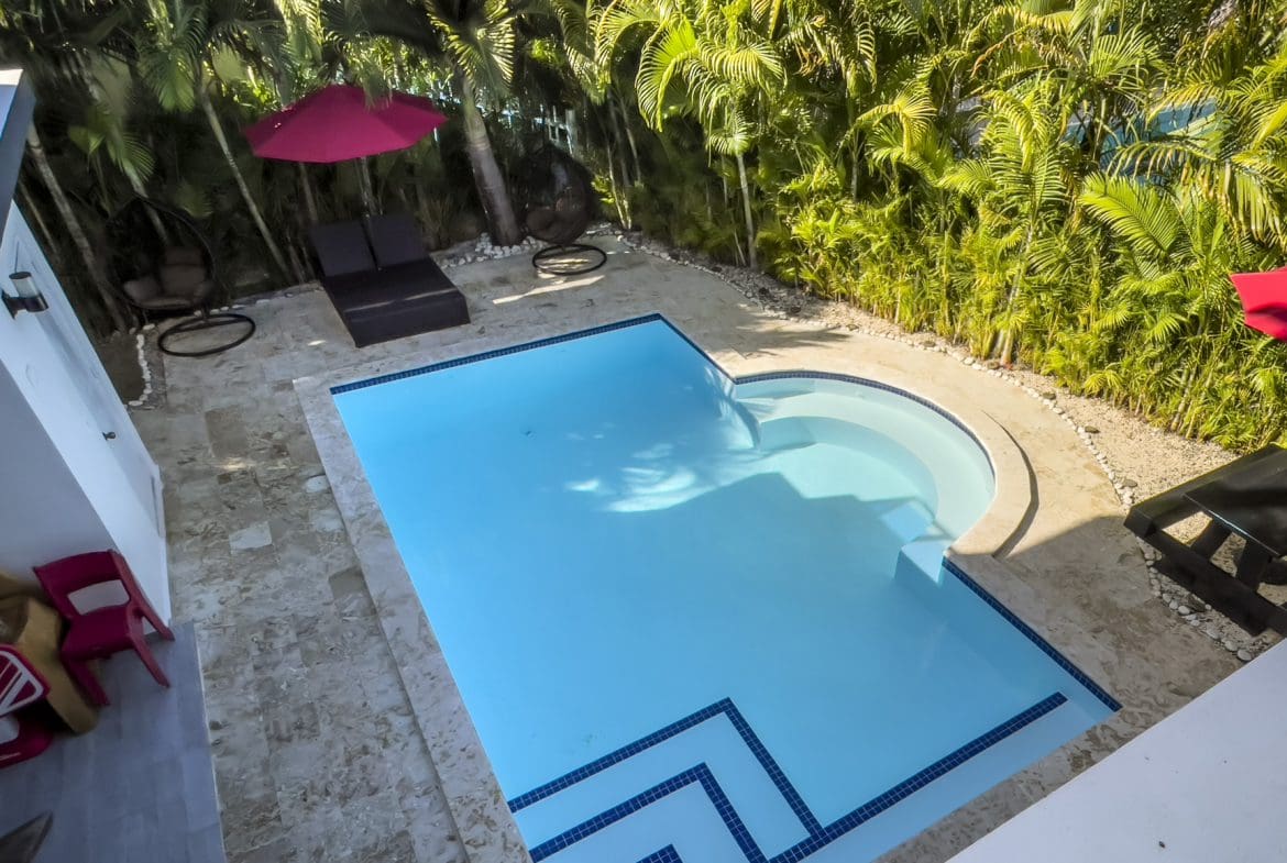buyDRproperty Luxury Sosúa Ocean Village villa for sale with a private pool and lush tropical landscaping. Sosua Real Estate