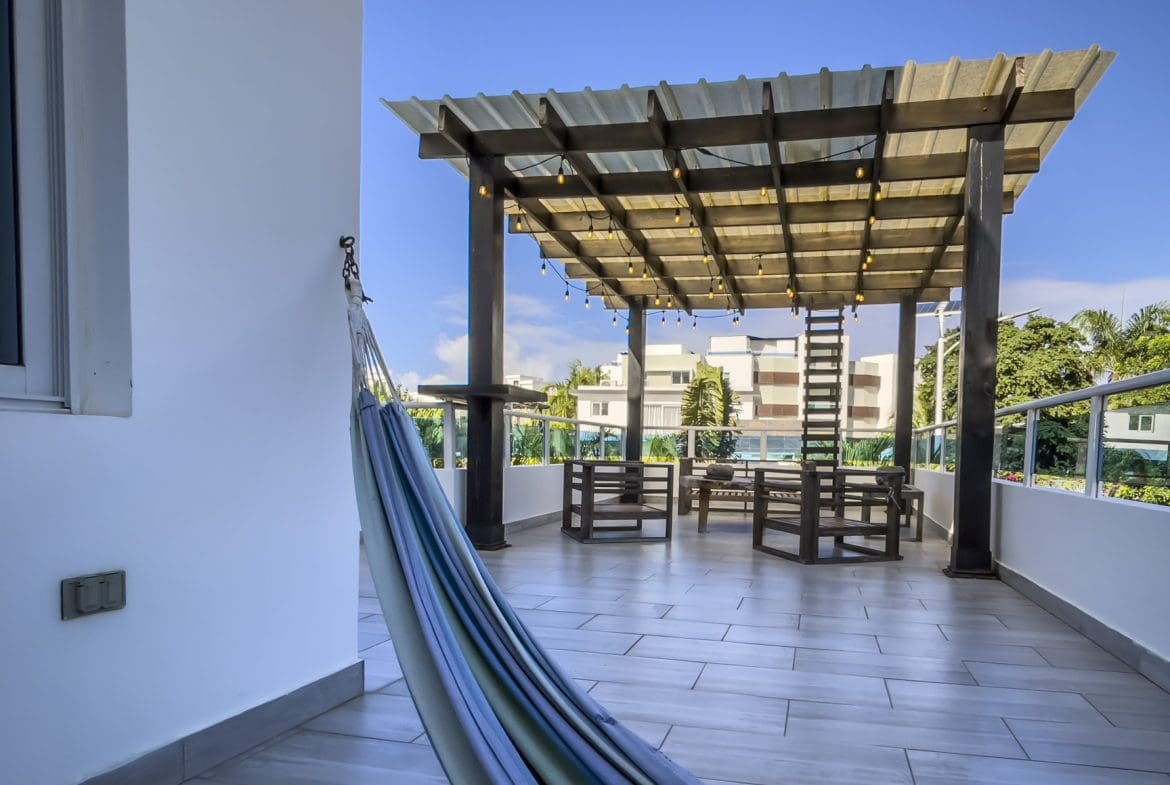 buyDRproperty Rooftop terrace of a modern 3-bedroom villa in Sosua Ocean Village, Dominican Republic, with a hammock and ocean views. Sosua Real Estate
