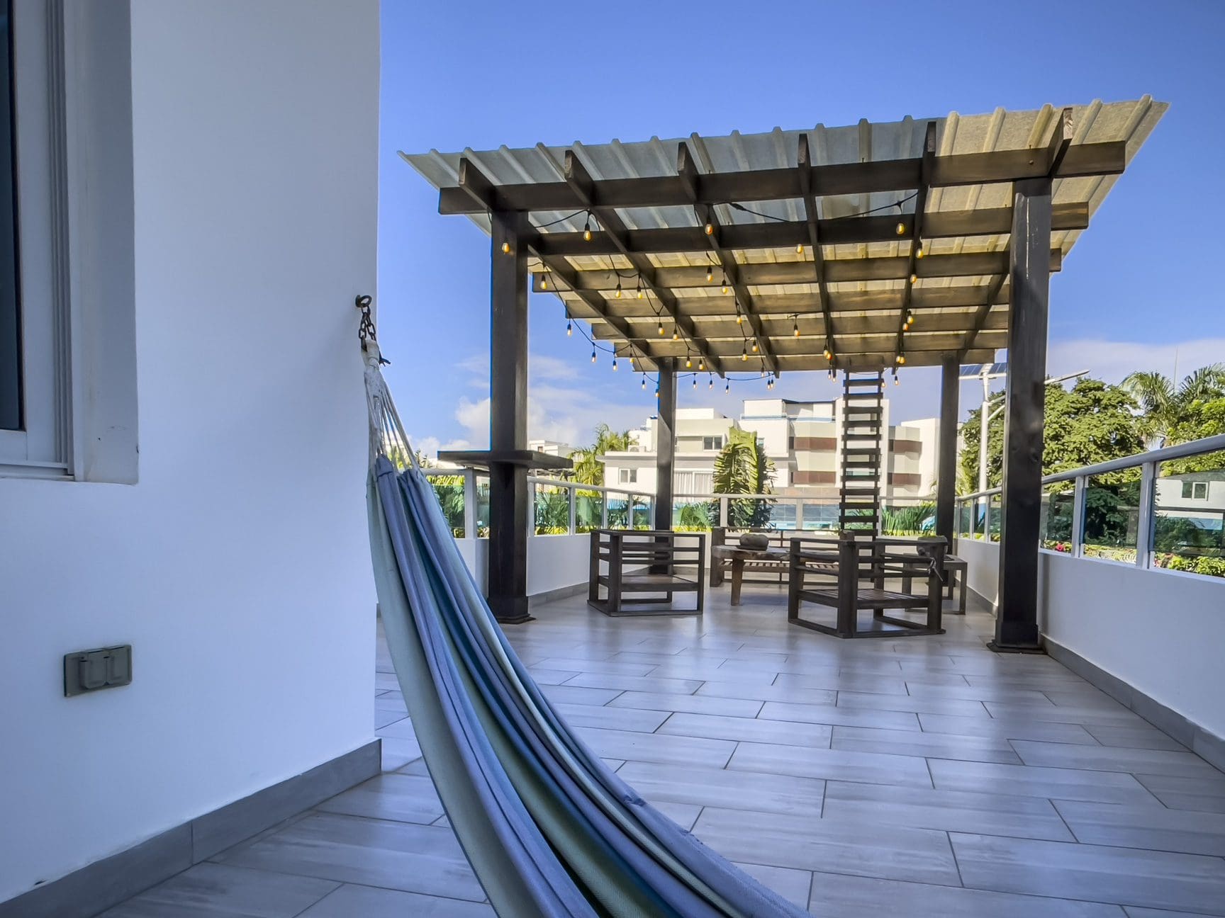buyDRproperty Rooftop terrace of a modern 3-bedroom villa in Sosua Ocean Village, Dominican Republic, with a hammock and ocean views. Sosua Real Estate
