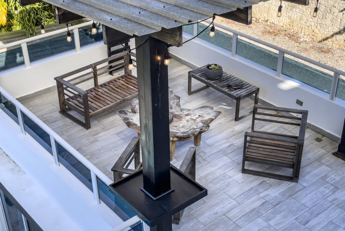 buyDRproperty Rooftop terrace of a 3-bedroom villa for sale in Sosúa Ocean Village, Dominican Republic, with outdoor furniture and ocean views. Sosua Real Estate