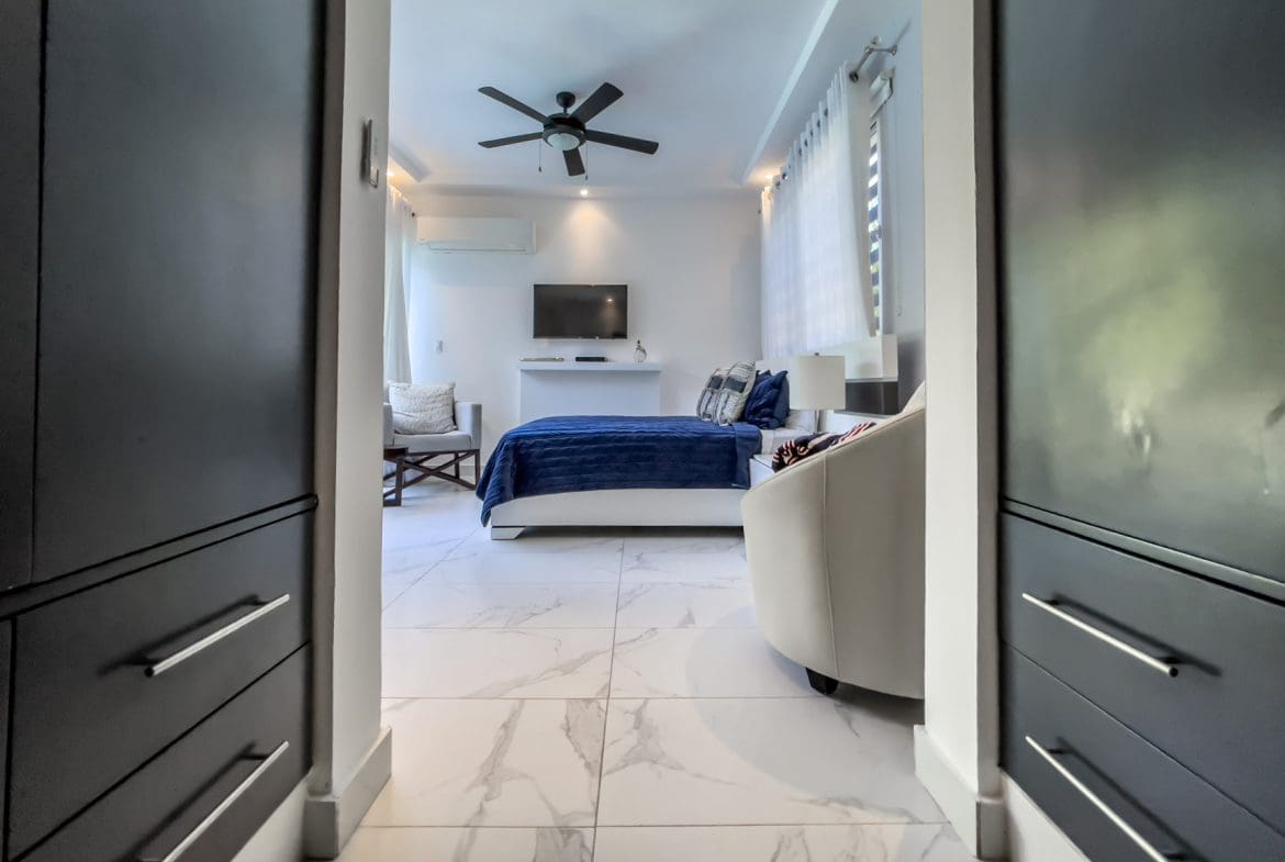 buyDRproperty Modern 3-bedroom villa interior in Sosúa Ocean Village, featuring a bedroom with ocean view. Sosua Real Estate