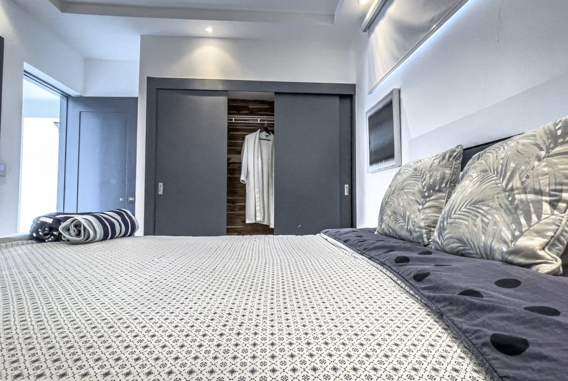 buyDRproperty Modern bedroom in a Sosúa Ocean Village villa for sale with stylish decor. Sosua Real Estate