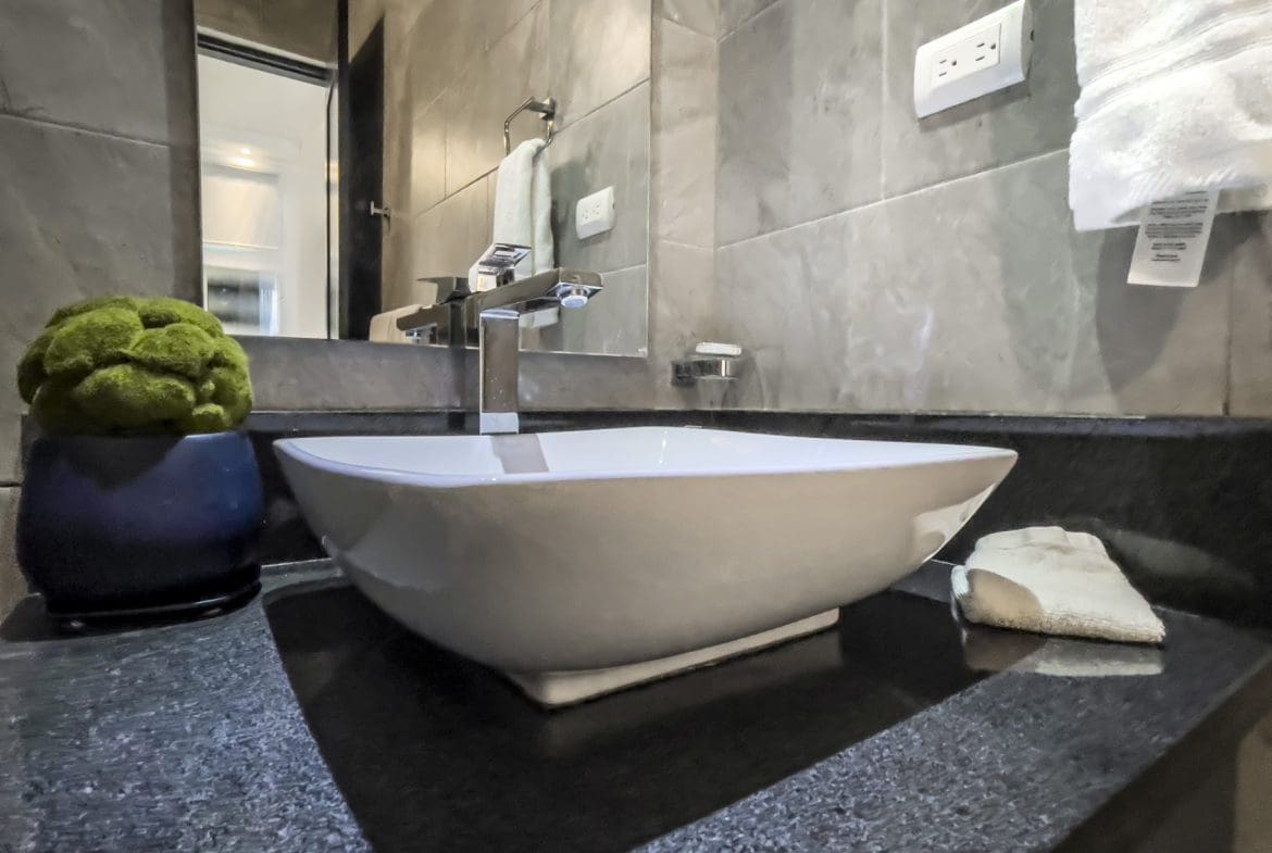 buyDRproperty Modern bathroom vanity with vessel sink in a Sosúa Ocean Village villa for sale. Sosua Real Estate