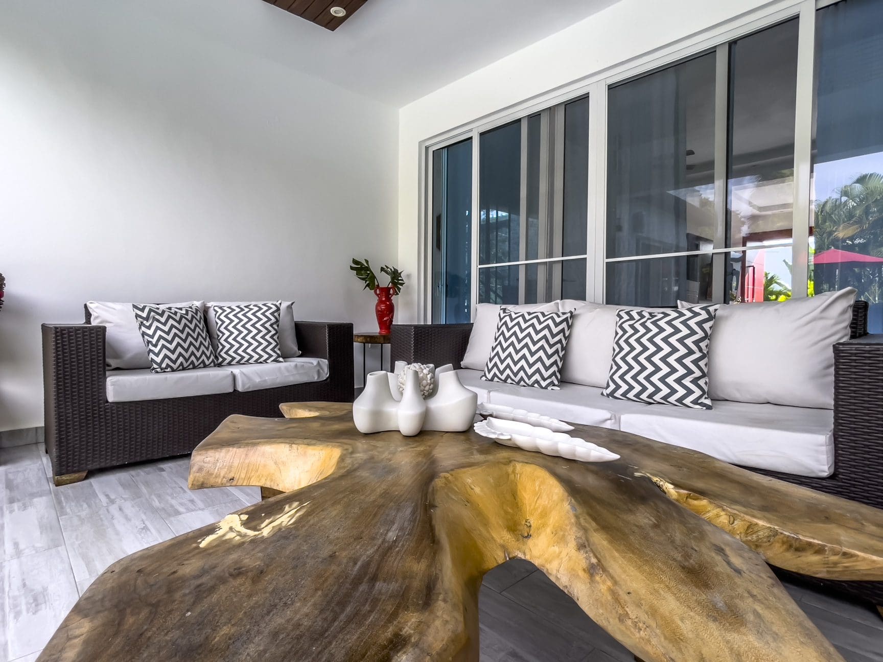 buyDRproperty Modern Sosúa Ocean Village villa living room with wooden coffee table and gray sofas. Sosua Real Estate