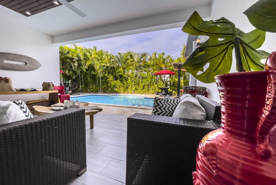 buyDRproperty Modern Sosúa Ocean Village villa for sale with pool and outdoor seating area. Sosua Real Estate