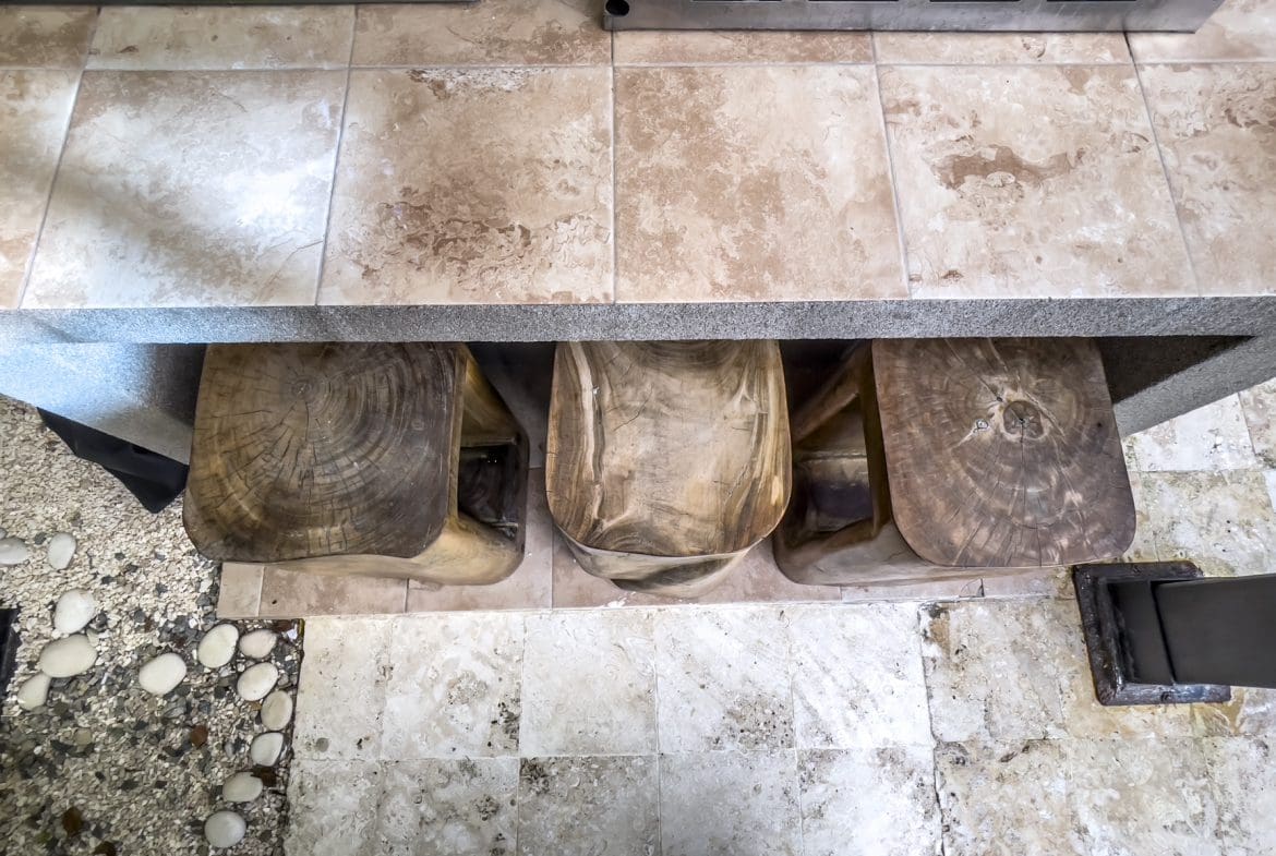 buyDRproperty Wooden stools under a countertop in a modern villa. Sosúa Ocean Village villa for sale. Sosua Real Estate
