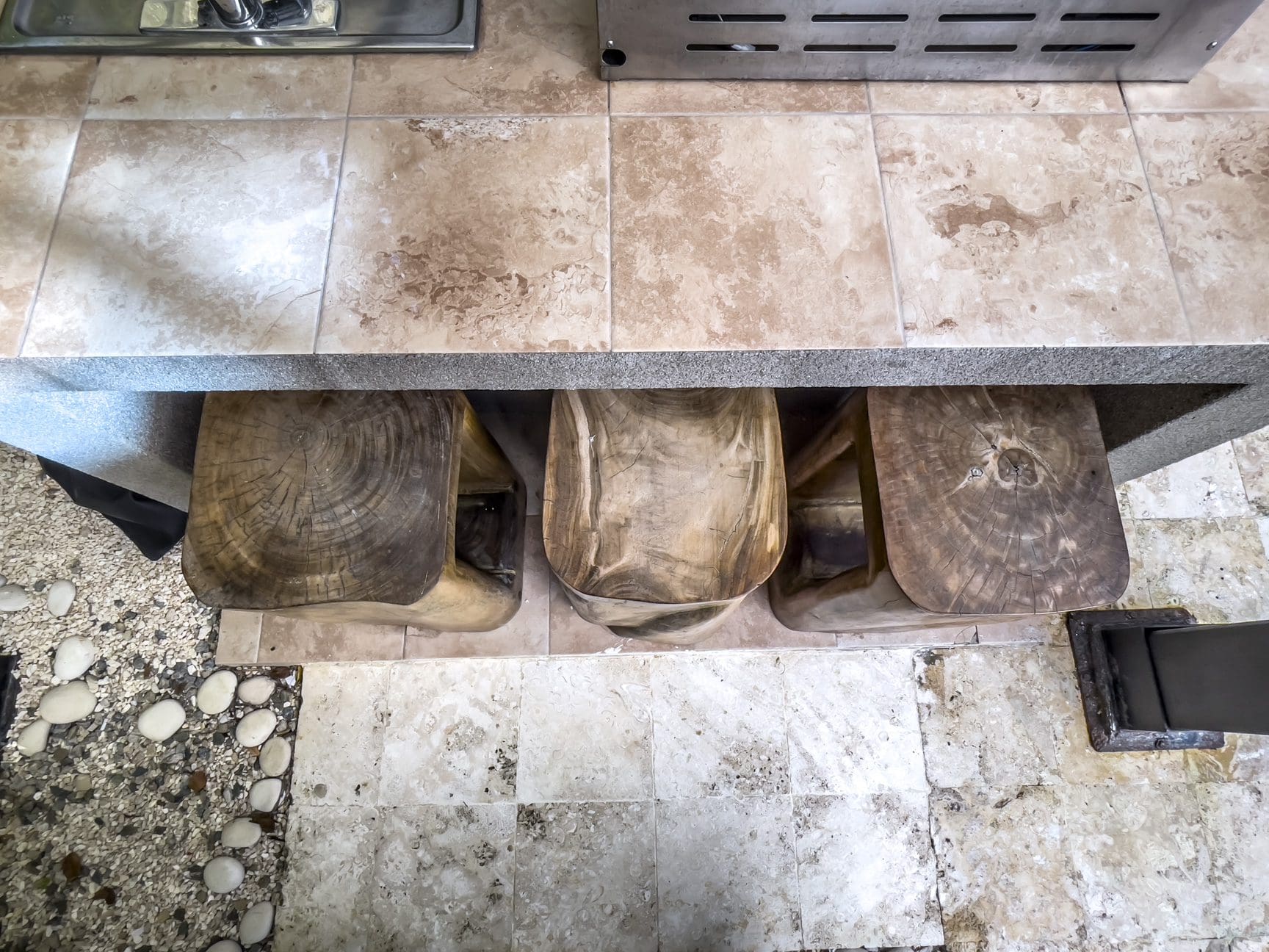 buyDRproperty Wooden stools under a countertop in a modern villa. Sosúa Ocean Village villa for sale. Sosua Real Estate
