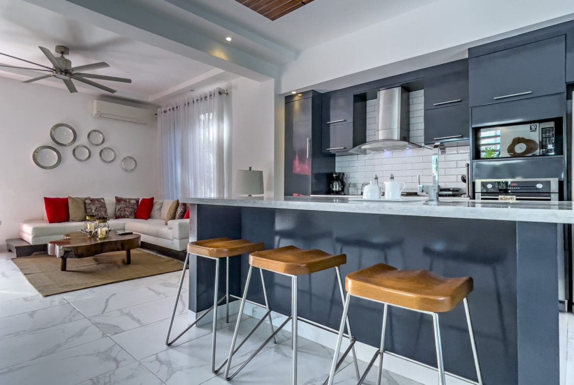 buyDRproperty Modern kitchen with breakfast bar in a Sosúa Ocean Village villa for sale. Sosua Real Estate