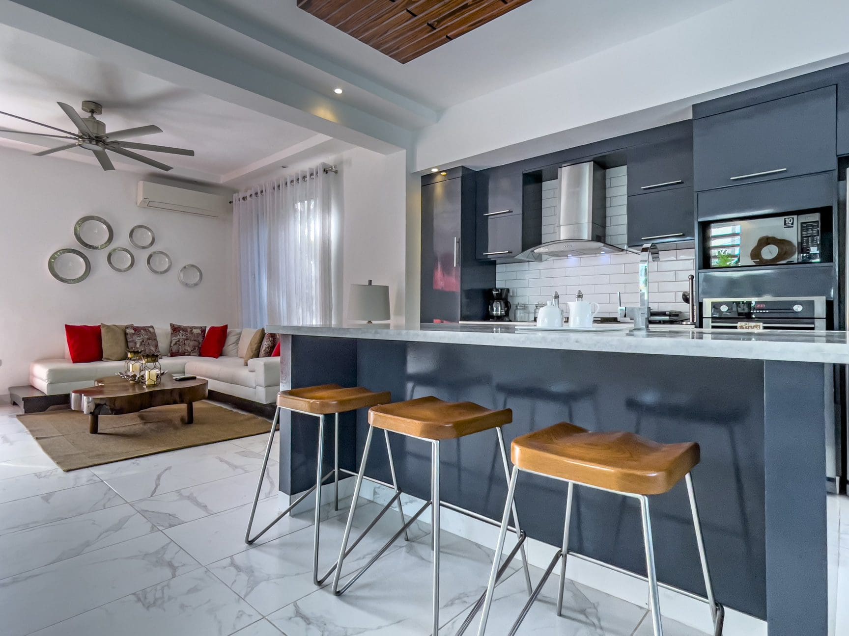 buyDRproperty Modern kitchen with breakfast bar in a Sosúa Ocean Village villa for sale. Sosua Real Estate