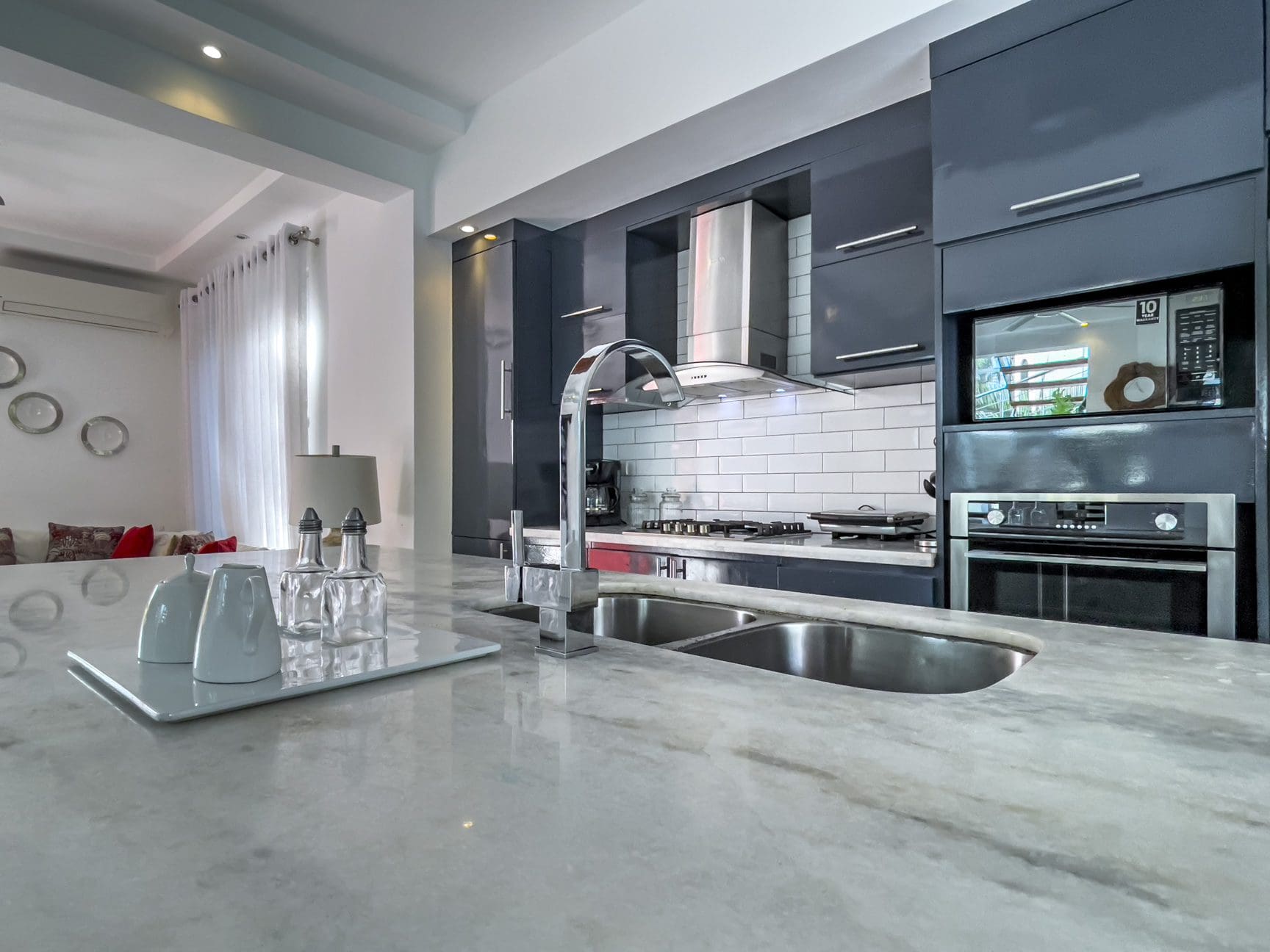 buyDRproperty Modern Sosúa Ocean Village kitchen with stainless steel sink and appliances. 3 Bed Villa For Sale. Sosua Real Estate