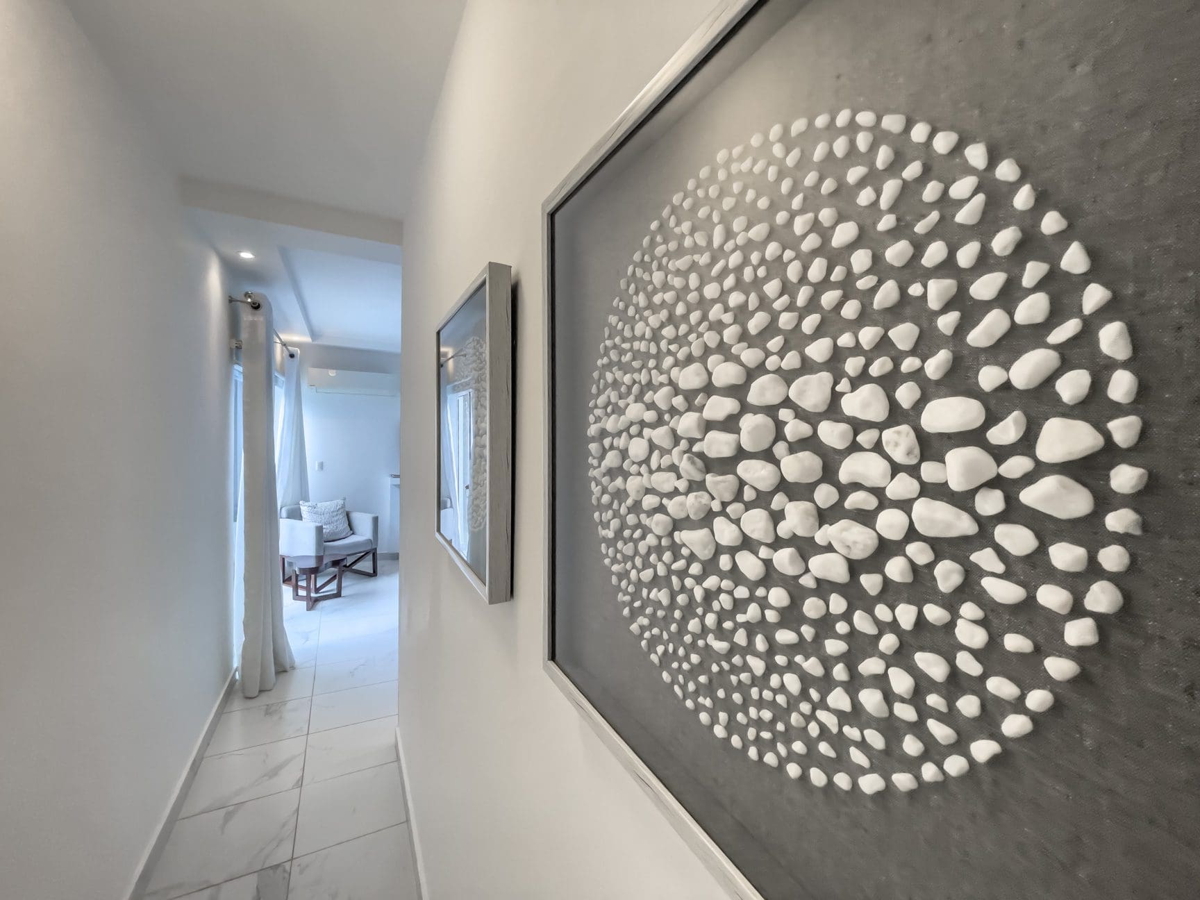 buyDRproperty Modern hallway in a Sosúa Ocean Village 3-bedroom villa for sale, featuring art. Sosua Real Estate