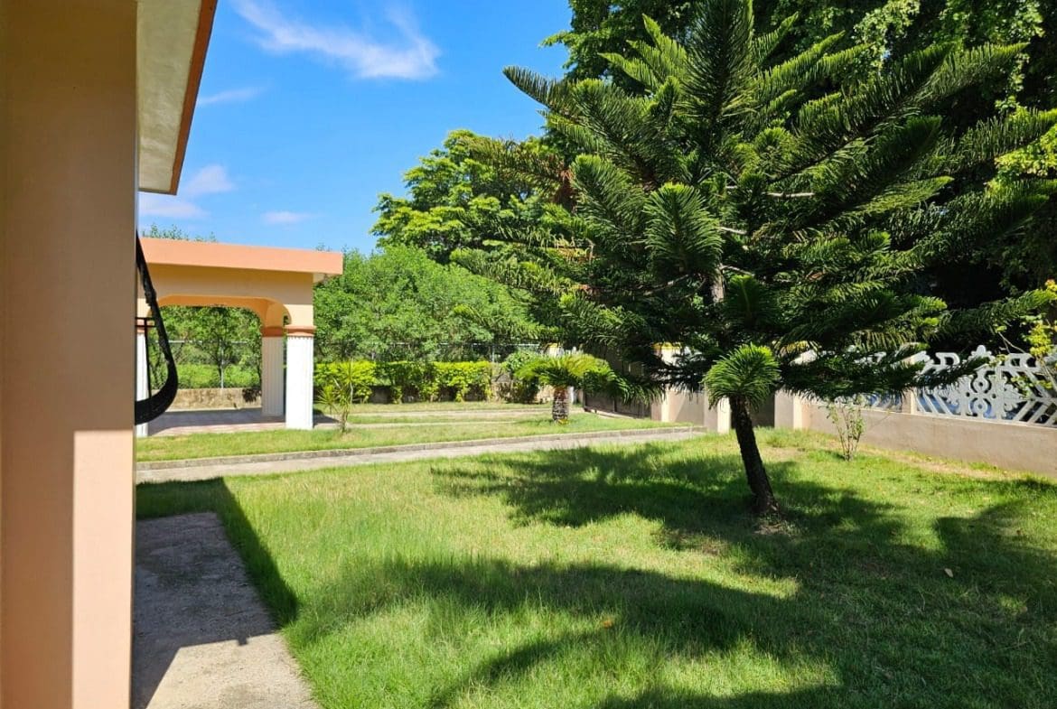 buyDRproperty Charming house in Cabarete for sale V5888CAB with a large tree and green lawn. Sosua Real Estate