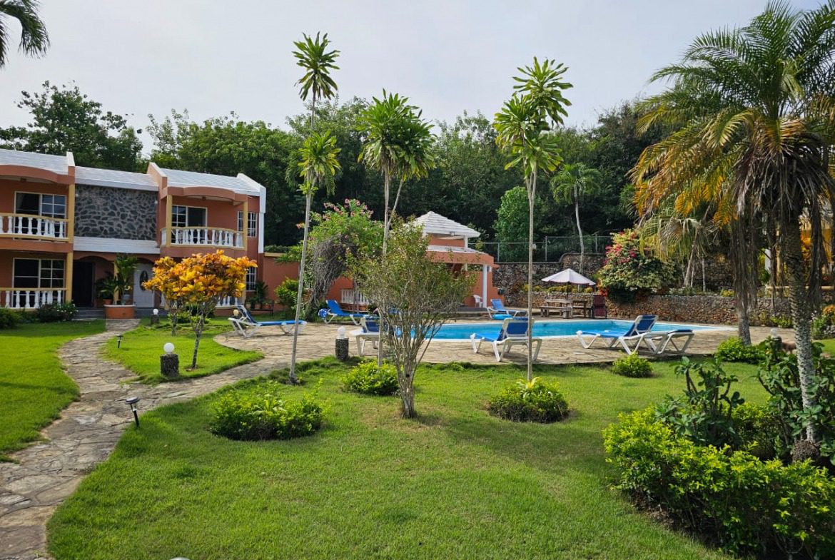 buyDRproperty Townhouse for sale near Sosua Center with pool and palm trees. Sosua Real Estate