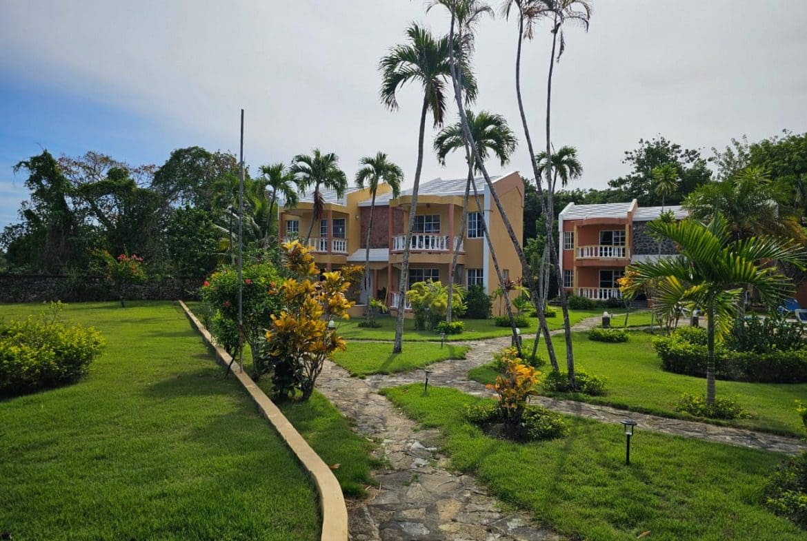 buyDRproperty Townhouse for sale close to SOSUA Center, with lush green landscaping. Sosua Real Estate