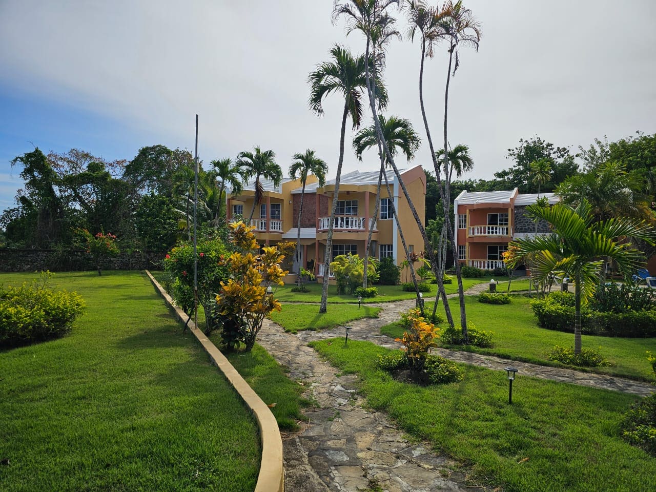 buyDRproperty Townhouse for sale close to SOSUA Center, with lush green landscaping. Sosua Real Estate