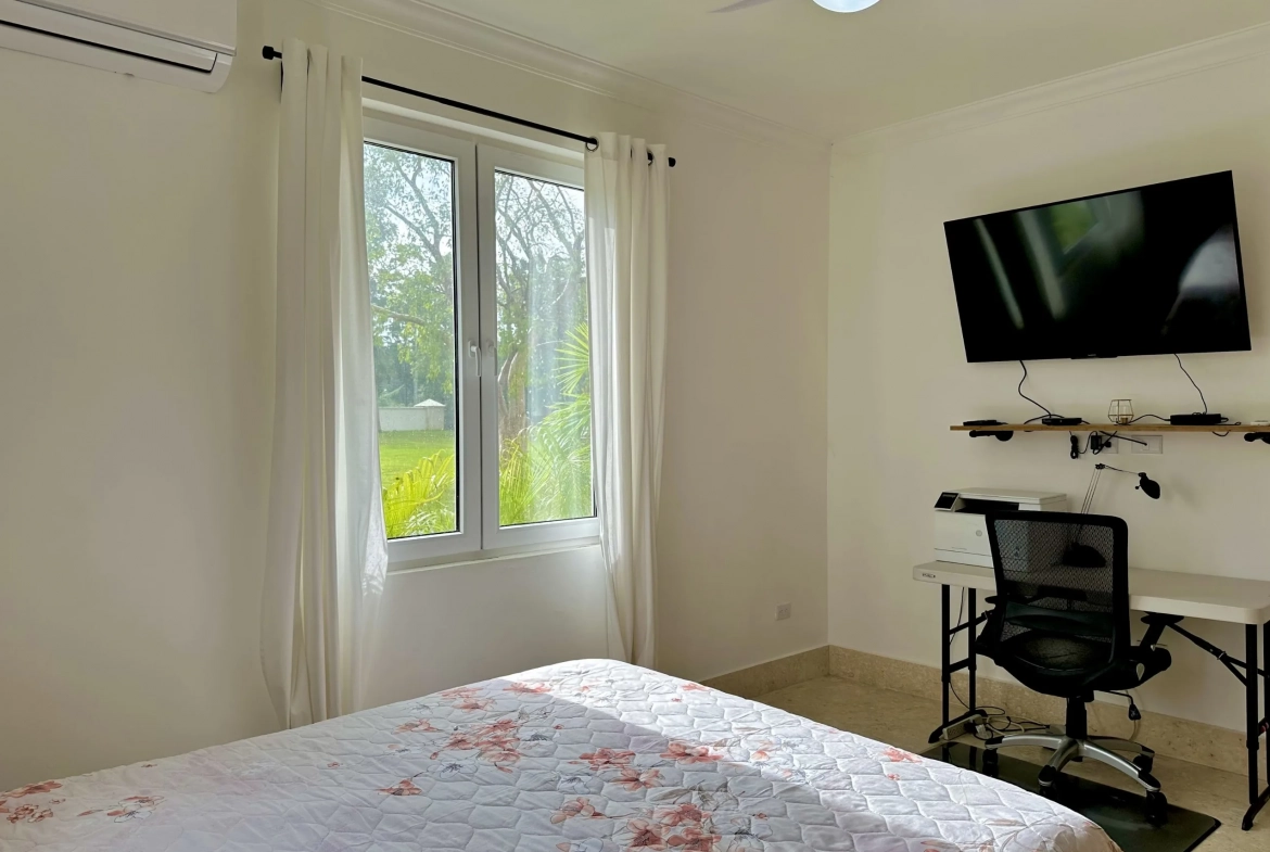 buyDRproperty 2-Bedroom Condo bedroom with window, desk, and TV Sosua Real Estate