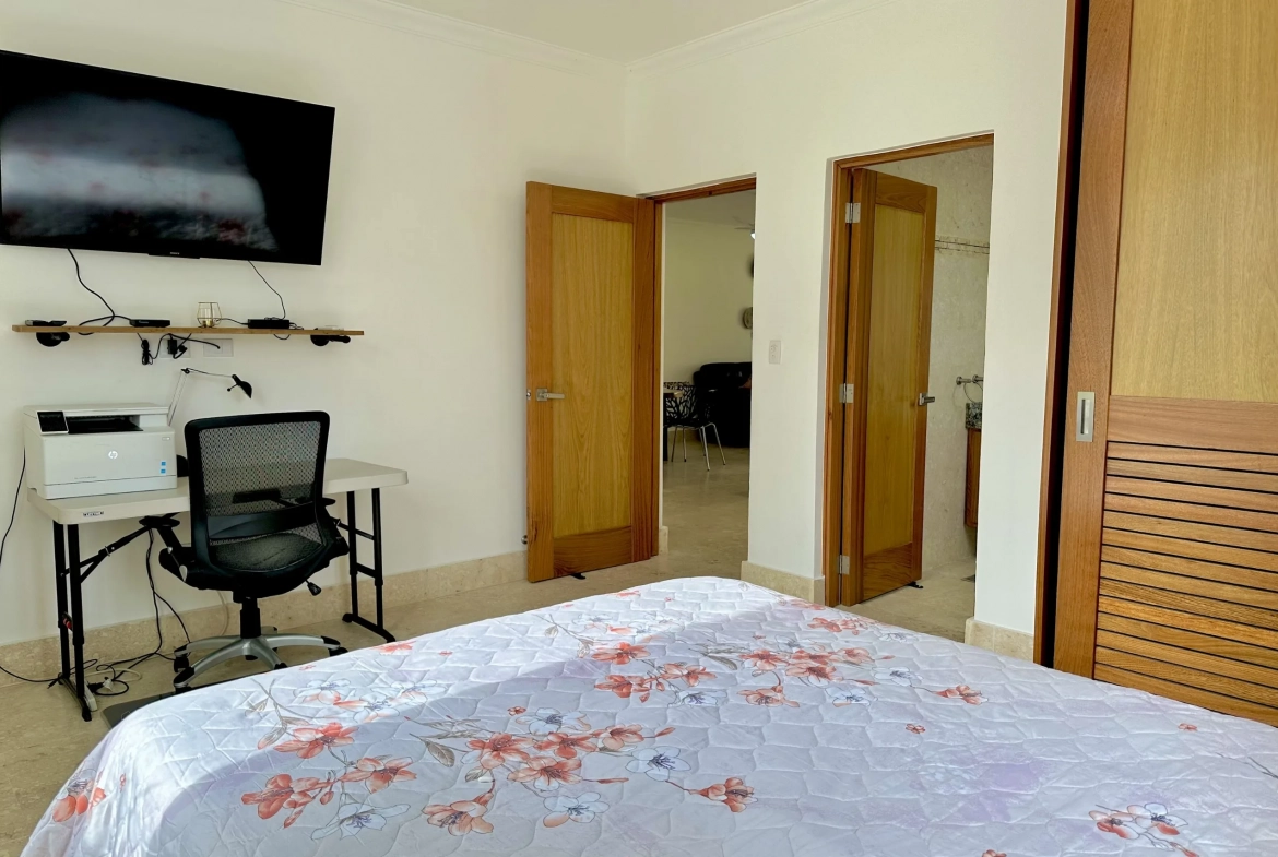 buyDRproperty Bedroom with a 2-bedroom condo bedspread, desk, and TV. Sosua Real Estate