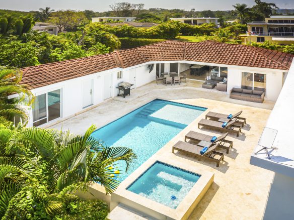 buyDRproperty Luxury villa for sale in Casa Linda with pool and hot tub on a sunny day. Sosua Real Estate