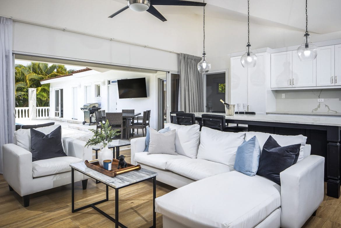 buyDRproperty Luxury living room in a Villa For Sale in Casa Linda with white furniture and open patio view. Sosua Real Estate