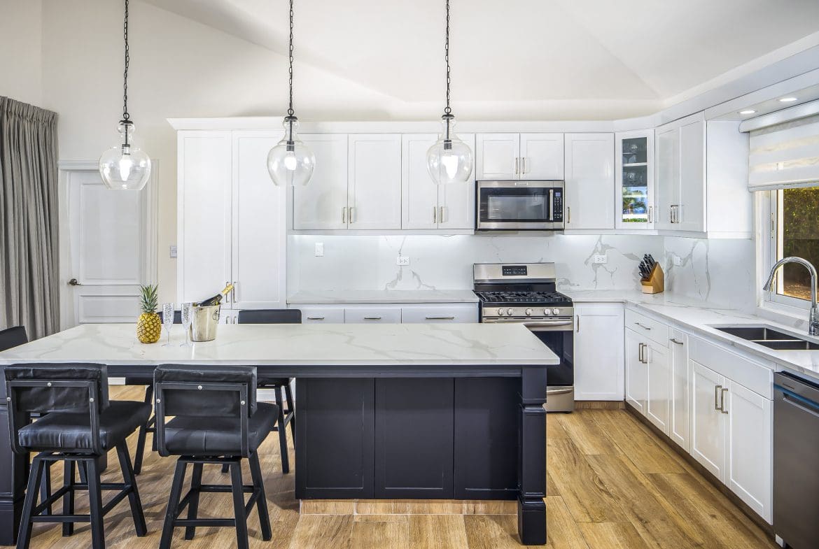 buyDRproperty Modern kitchen with island and bar stools in a Villa For Sale in Casa Linda. Sosua Real Estate