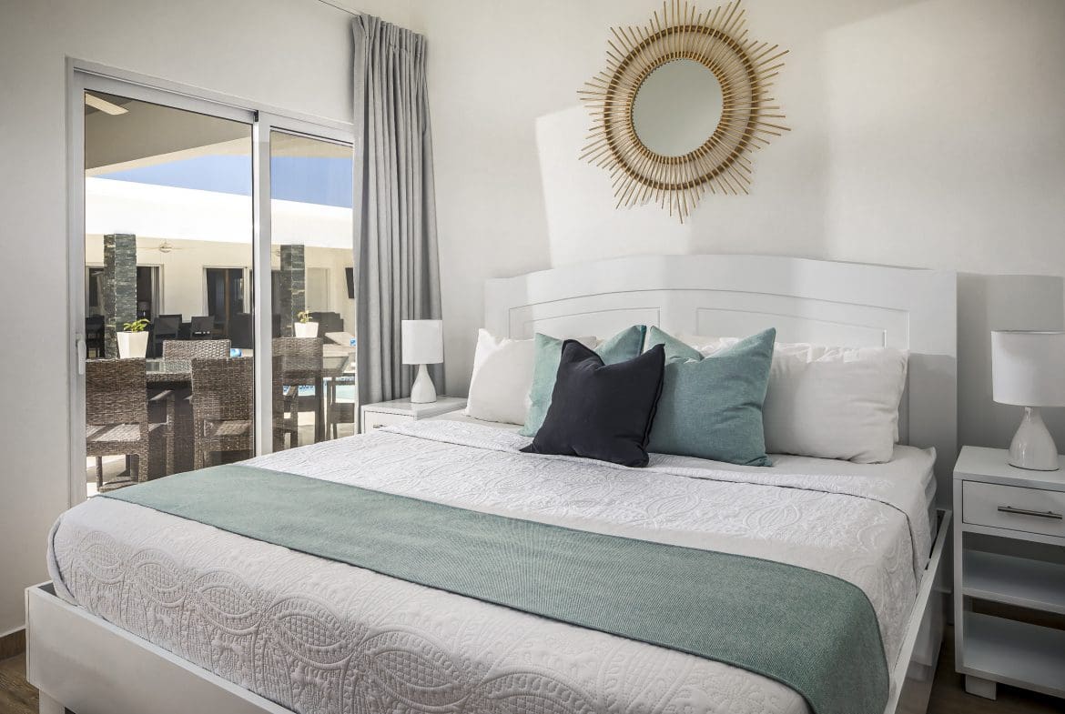buyDRproperty Bedroom in a Villa For Sale in Casa Linda with king-size bed and outdoor view Sosua Real Estate
