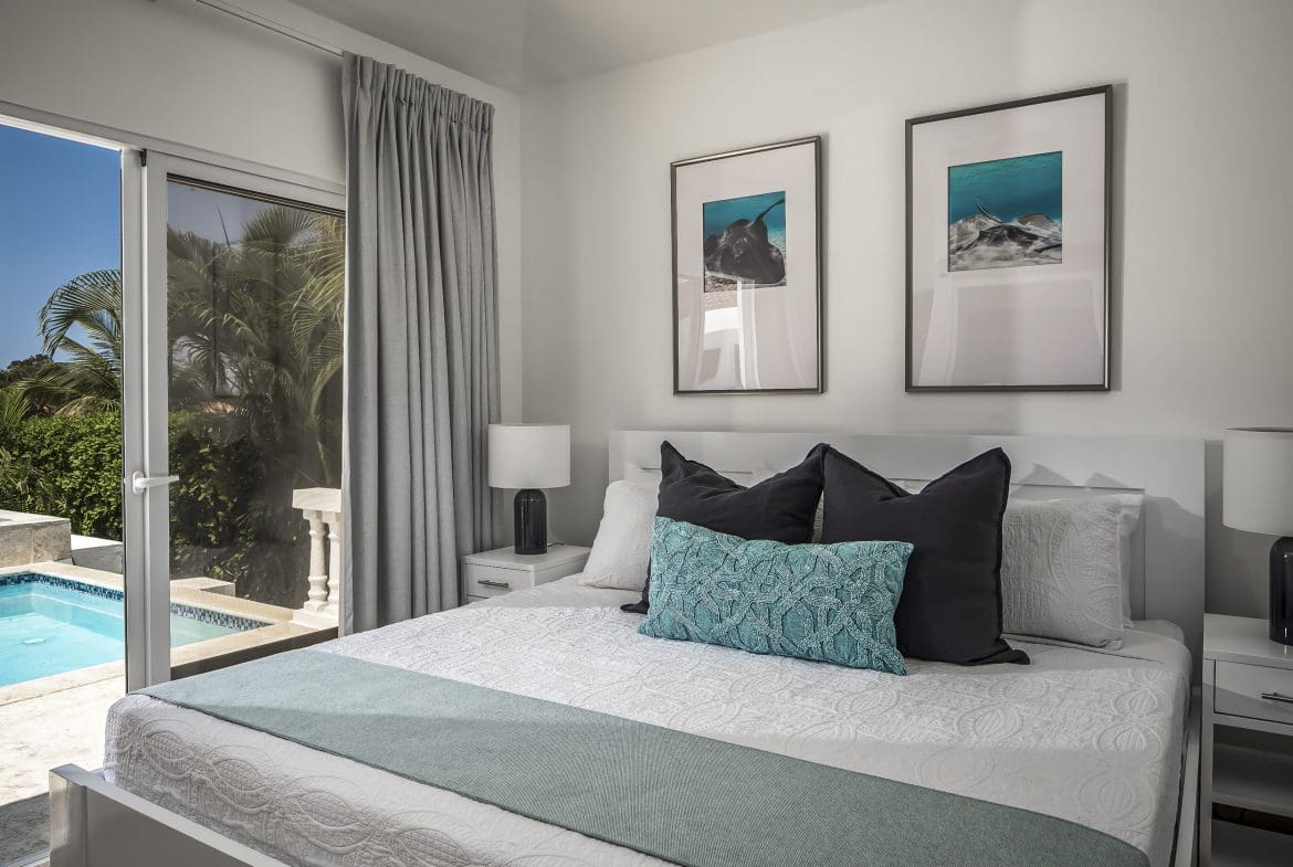 buyDRproperty Modern bedroom in a Casa Linda villa for sale, featuring a pool view and stylish decor. Sosua Real Estate