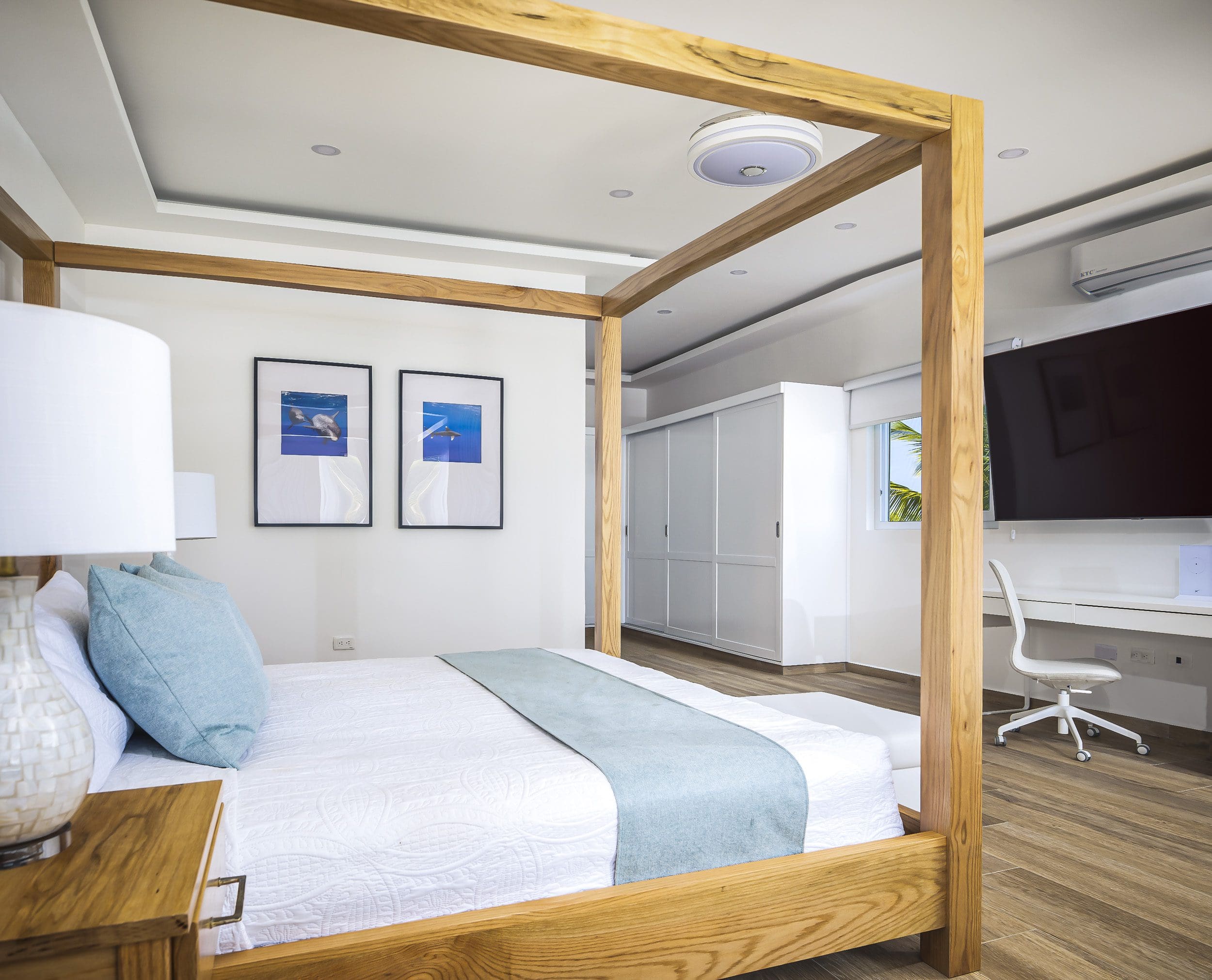 buyDRproperty Bedroom in a Villa For Sale in Casa Linda with a four-poster bed, desk, and artwork. Sosua Real Estate