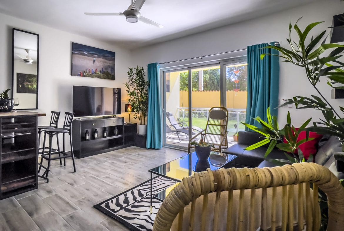 buyDRproperty Stylish one bedroom condo living room with modern furniture and a view Sosua Real Estate