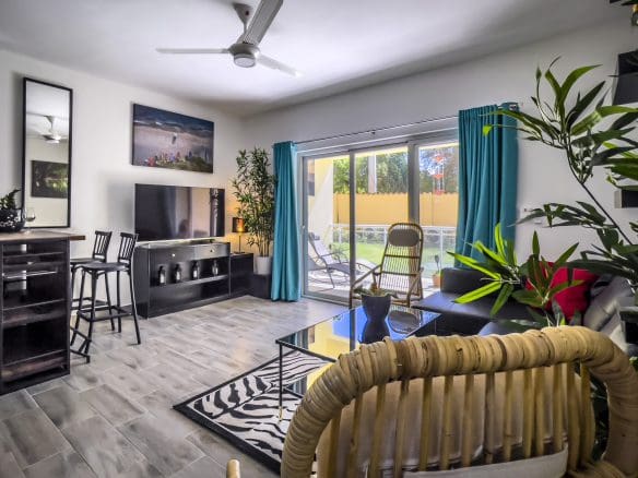 buyDRproperty Stylish one bedroom condo living room with modern furniture and a view Sosua Real Estate