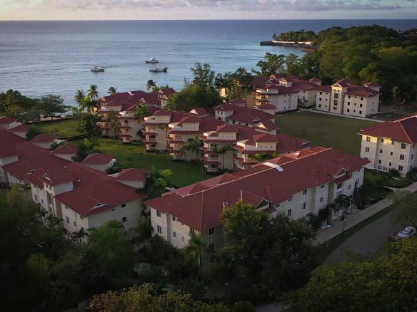 buyDRproperty Aerial view of a resort with red roofs and ocean view. 3 bedroom Pre-Construction For Sale. Sosua Real Estate