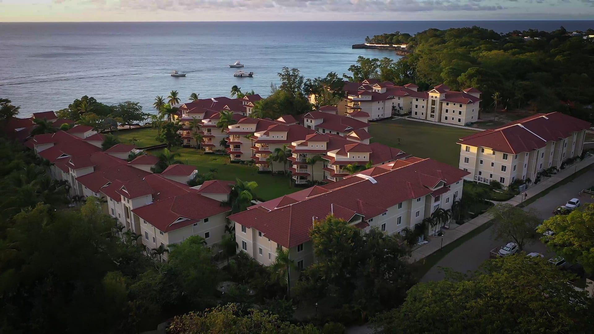 buyDRproperty Aerial view of a resort with red roofs and ocean view. 3 bedroom Pre-Construction For Sale. Sosua Real Estate