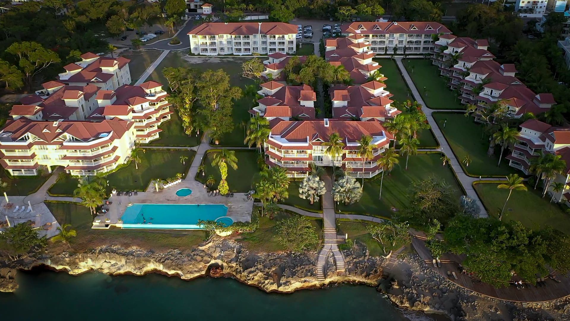 buyDRproperty Aerial view of luxury resort with a swimming pool and ocean access. Special Offer Sosua Real Estate