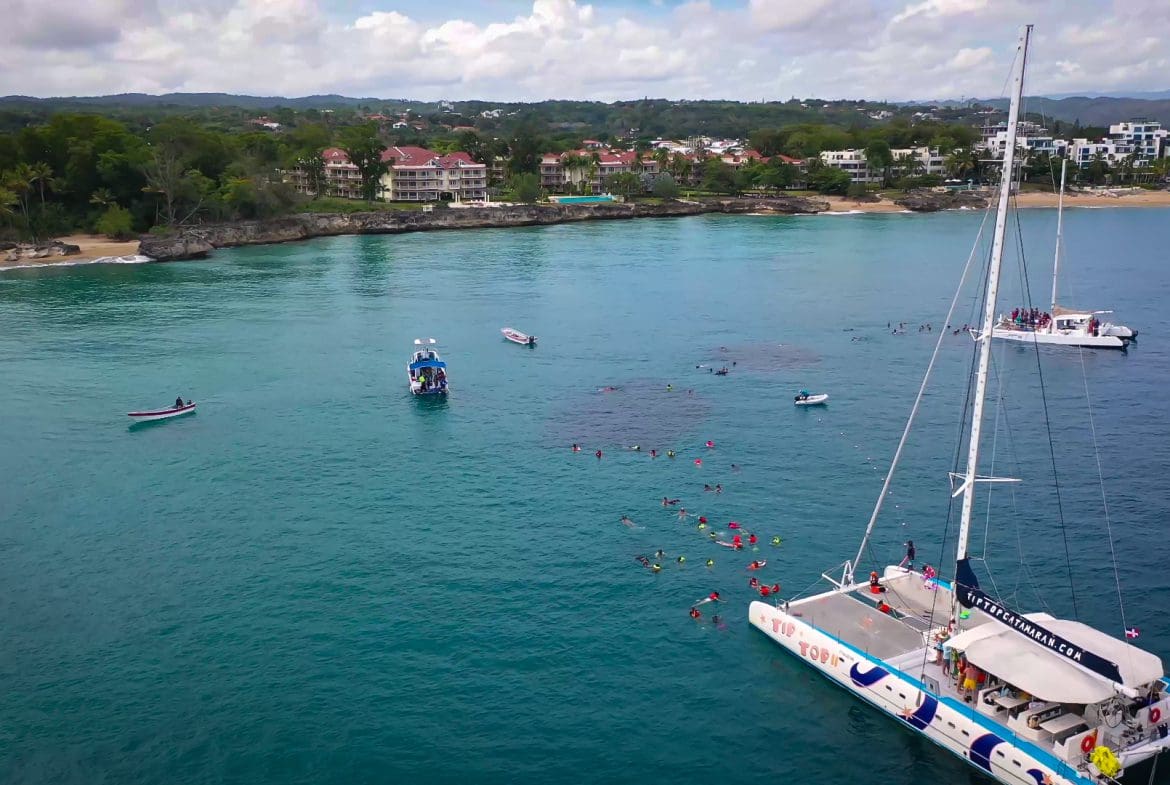 buyDRproperty Catamaran with snorkelers enjoying the water near the coast. Special Offer available. Sosua Real Estate