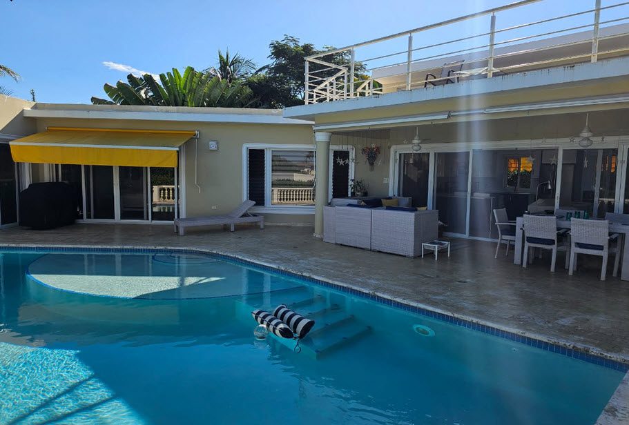 buyDRproperty Casa Linda Villa with pool, patio, and yellow awning. Sosua Real Estate