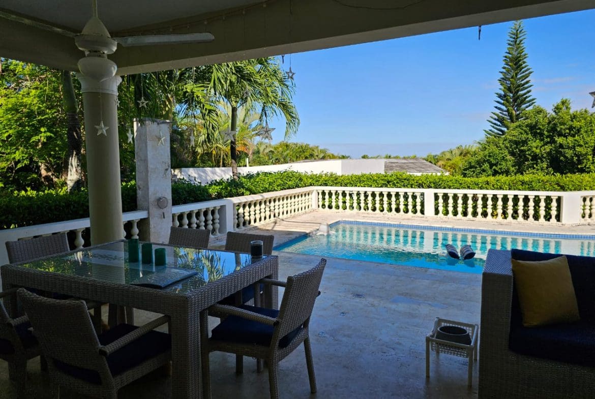 buyDRproperty Outdoor patio with dining set and pool at a Casa Linda Villa. Sosua Real Estate