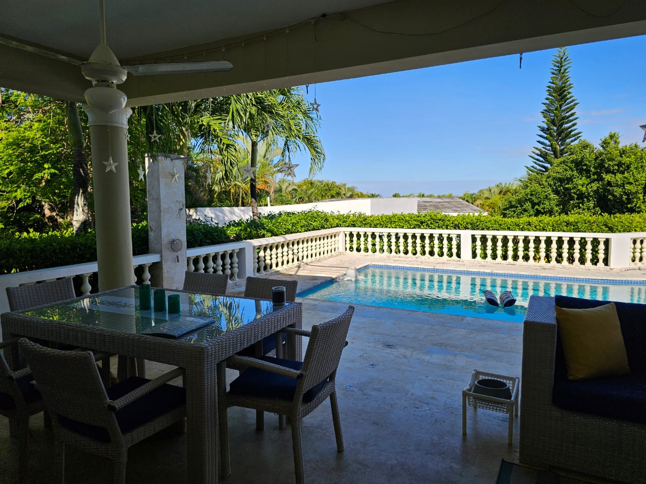 buyDRproperty Outdoor patio with dining set and pool at a Casa Linda Villa. Sosua Real Estate