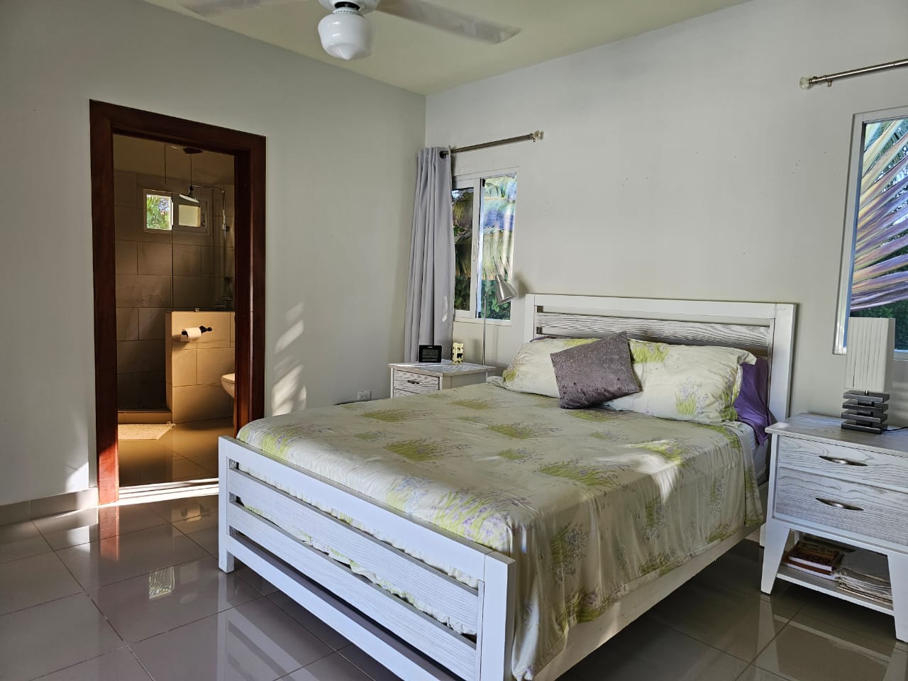 buyDRproperty Bedroom in a Casa Linda Villa with white bed frame and ensuite bathroom. Sosua Real Estate