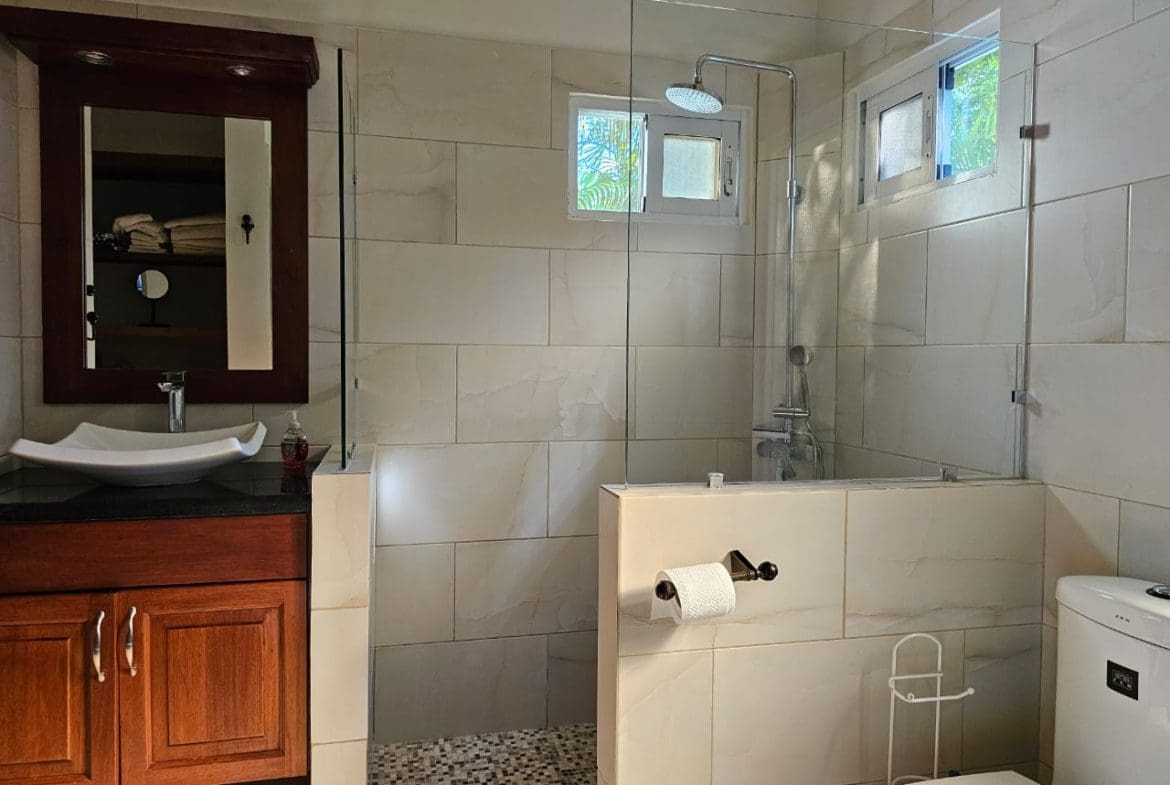 buyDRproperty Modern bathroom with glass shower and Casa Linda Villa style. Sosua Real Estate