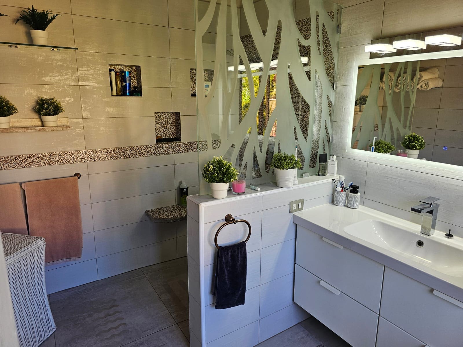 buyDRproperty Modern bathroom with unique glass partition and ocean views reflected in the mirror, Villa For Sale. Sosua Real Estate