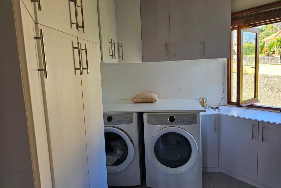 buyDRproperty Laundry room in a villa with modern appliances and storage. Sosua Real Estate