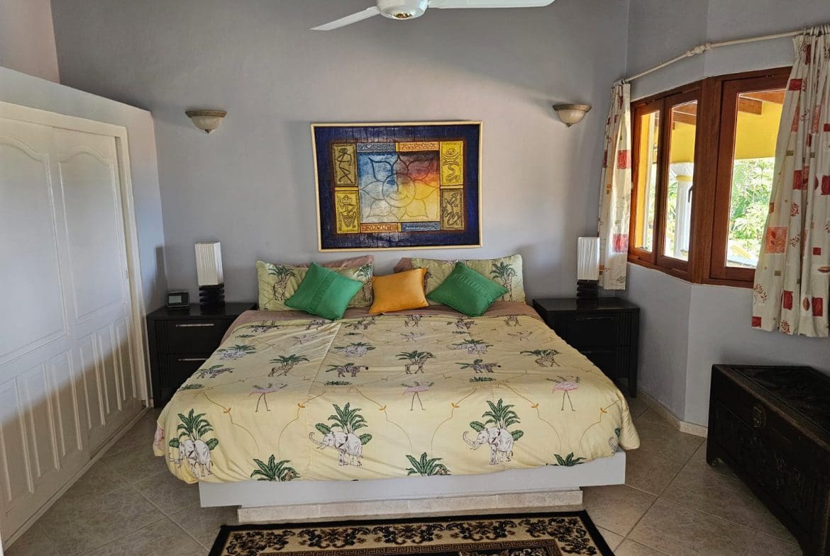buyDRproperty Bedroom in a villa with elephant-themed bedding and ocean views. Villa for sale. Sosua Real Estate