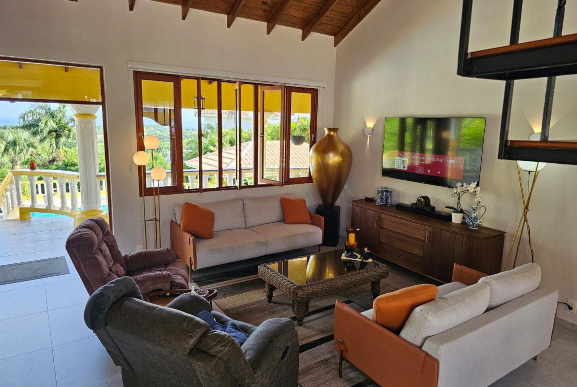 buyDRproperty Living room in villa for sale featuring ocean views, comfortable seating, and modern decor. Sosua Real Estate