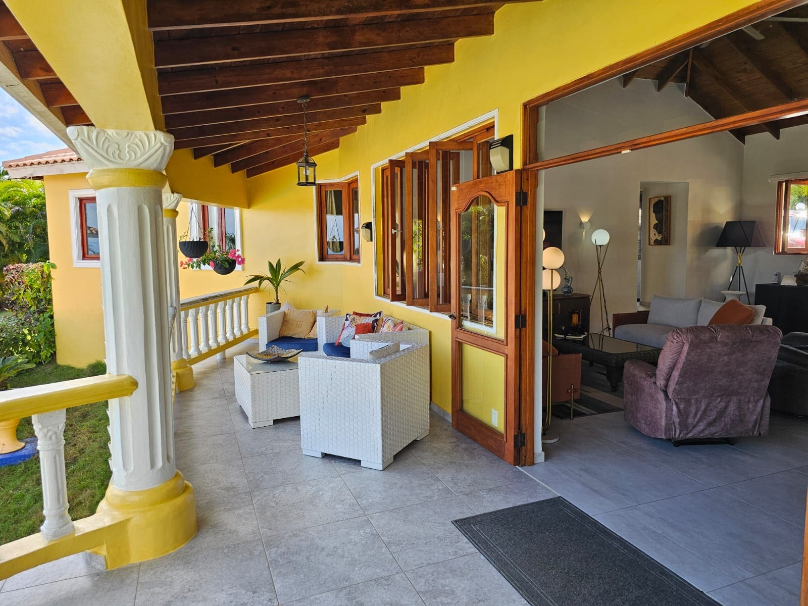 buyDRproperty Villa for sale with ocean views: covered patio with seating and open doorway. Sosua Real Estate