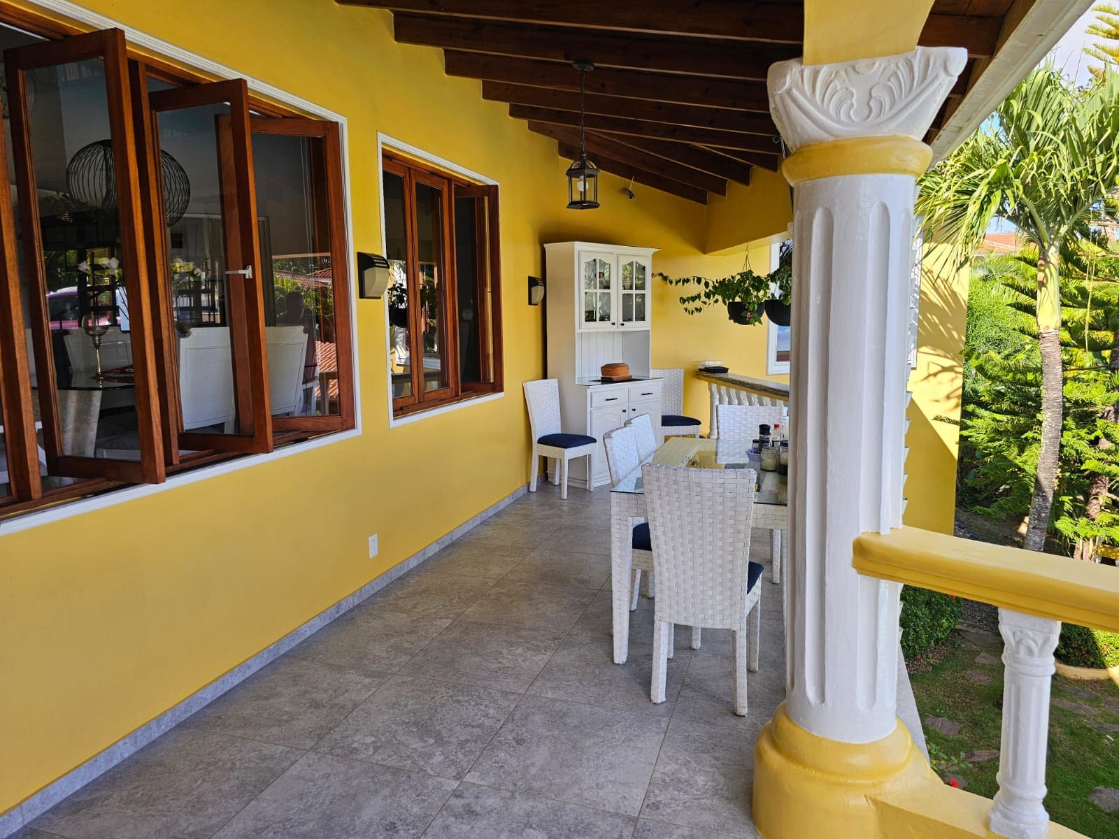buyDRproperty Covered patio with dining set and ocean views at a luxury villa for sale. Sosua Real Estate