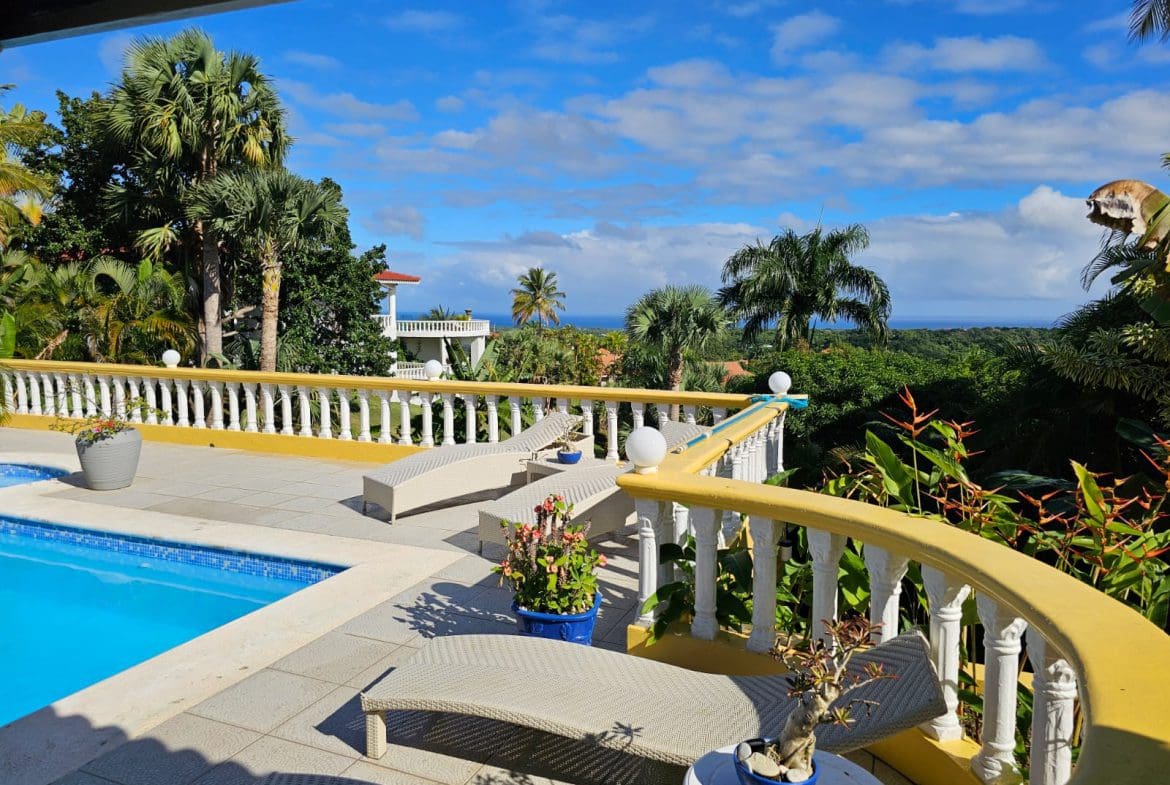 buyDRproperty Ocean view villa for sale in Sosua with a pool and lounge chairs Sosua Real Estate