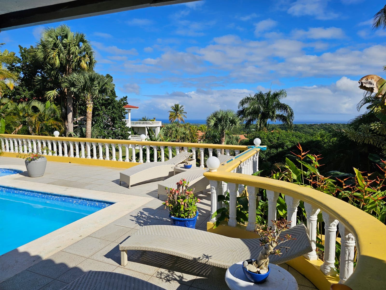 buyDRproperty Ocean view villa for sale in Sosua with a pool and lounge chairs Sosua Real Estate