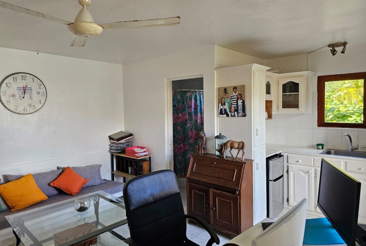 buyDRproperty Living area with kitchen in a villa for sale, featuring ocean views. Clock reads 11:57. Sosua Real Estate