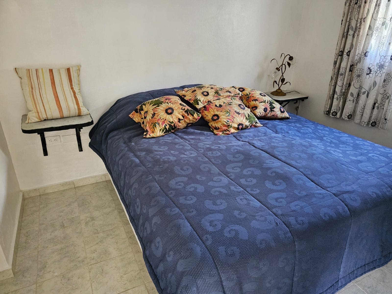 buyDRproperty Bedroom in Ocean View Villa with blue bedding and floral pillows. Sosua Real Estate